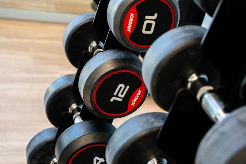 a row of dumbbells in a gym at Staycity Aparthotels Paris La Defense in Courbevoie