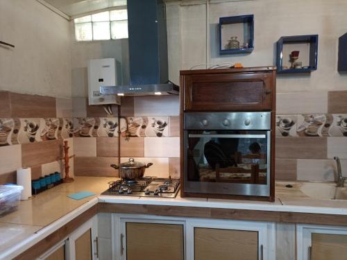 a kitchen with a stove and a stove top oven at Suite home beldj in Tipaza