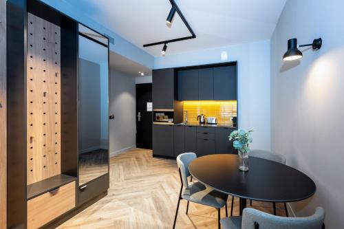 a kitchen and dining room with a table and chairs at Staycity Aparthotels Paris La Defense in Courbevoie