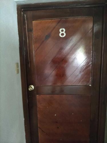 a wooden door with the number eight on it at HOTEL PREMIER RIOVERDE in Río Verde