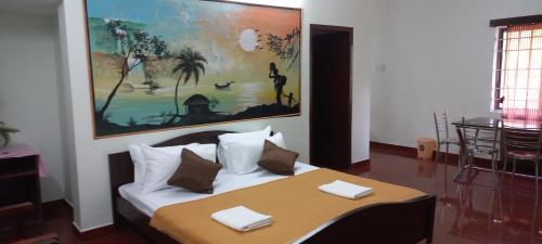 a bedroom with a bed with a painting on the wall at iSTAYS - Loop Road, Yercaud in Yercaud