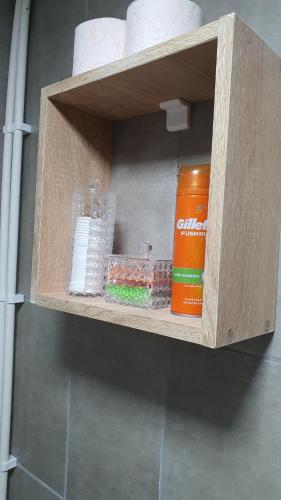 a wooden shelf with toiletries and a can on it at Sîrbu Orsova in Orşova