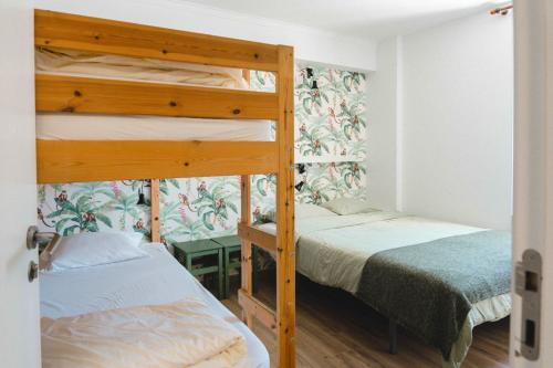 two bunk beds in a small room with a bed at Cascais Bay Hostel in Cascais