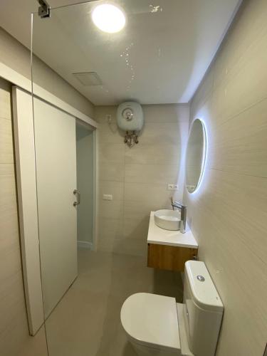 a bathroom with a toilet and a sink and a mirror at Salinetas Beach. in Telde