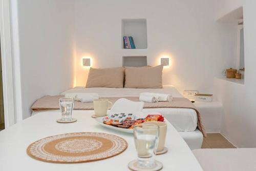 a bedroom with a bed and a table with a plate of food at LE PETIT Ενα μικρό αλλά όμορφο σπίτι in Stení
