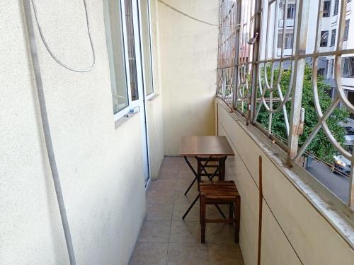 a small table in a room with a window at Museum Hostel in Tbilisi City