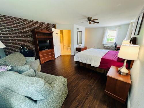 a hotel room with a bed and a couch at Inn at Cemetery Hill in Gettysburg