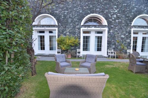 a patio with chairs and a table in front of a building at Villa Margherita in Levanto