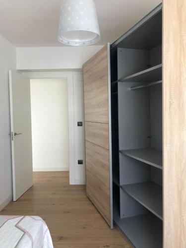 a bedroom with a closet with a large wooden cabinet at ApartamentoValleTena9 in Sabiñánigo