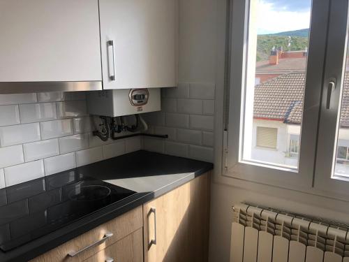 a kitchen with a sink and a window at ApartamentoValleTena9 in Sabiñánigo