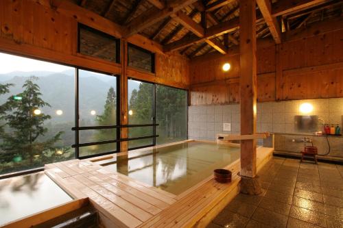 a large room with a swimming pool in a building at Hotel Fuki no Mori in Nagiso