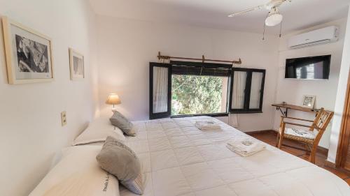 En eller flere senger på et rom på Posada de la Flor
