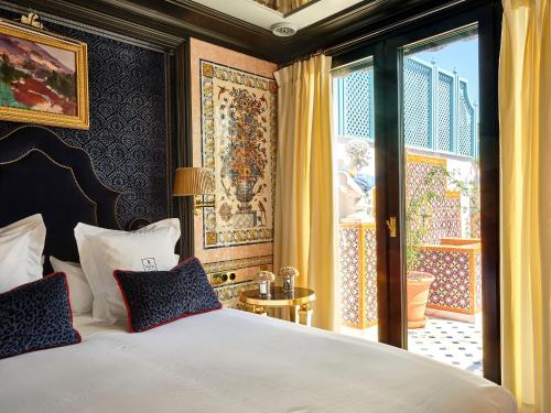 a bedroom with a large bed and a window at Hotel Boutique Triana House in Seville