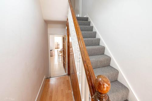 a staircase in a home with white walls at Cheerful 4 bedrooms home 8 mn to train station in Plumstead