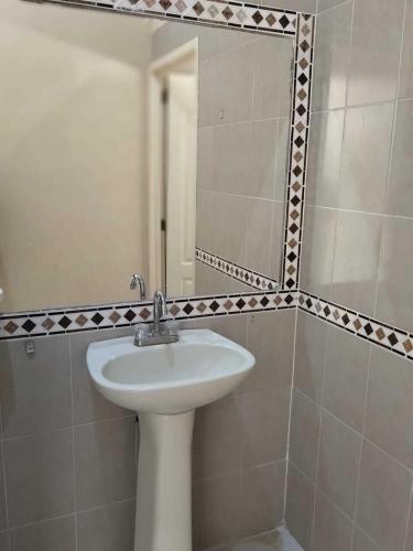 a bathroom with a sink and a mirror at HOTEL PREMIER RIOVERDE in Río Verde