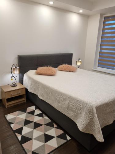 a bedroom with a bed and a checkered floor at Barbora apartament in Druskininkai