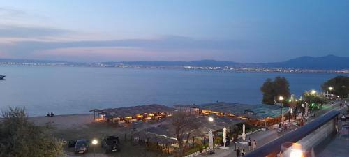 a view of a lake at night with tents and people at Dimos Sunny & Luxury Central House !!! in Perea