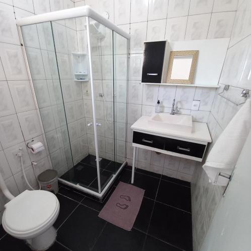 a small bathroom with a toilet and a sink at Casa Colomba in Búzios