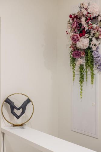 a mirror on a table with a bouquet of flowers at Diamond Luxury Rooms in Split