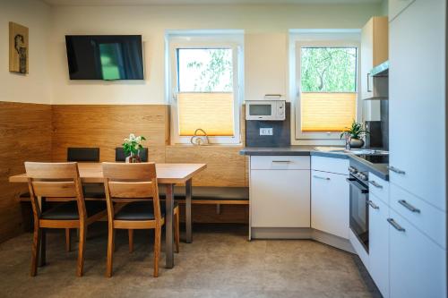 a kitchen with a table and chairs in a room at Karglhof Villa in Faak am See