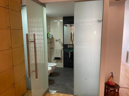 a bathroom with a white toilet and a sink at Apartamento Elobey Cabo de Gata in El Cabo de Gata