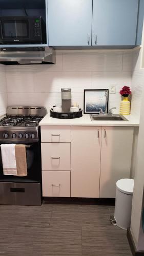 a kitchen with a stove and a sink at Tropical Oasis by the beach and shops, with pool in Riviera Beach