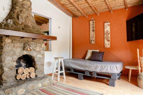 a bedroom with a bed and a stone fireplace at Rústic-HOUSE Envigado in Envigado