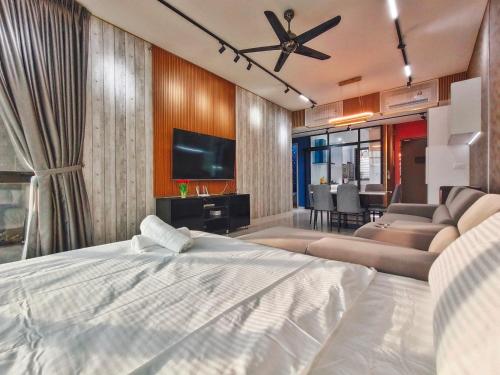 a bedroom with a bed and a living room at Beacon Executive Suite at Georgetown for 10pax and 2 BED ROOM in George Town