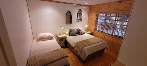 Ένα ή περισσότερα κρεβάτια σε δωμάτιο στο Forest Homes 15