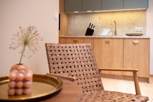 a kitchen with a table and a chair with a pineapple on it at Monciak55 Sopot Apartments in Sopot