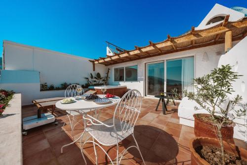 a patio with a table and chairs on a roof at Kalkan Han Hotel in Kalkan