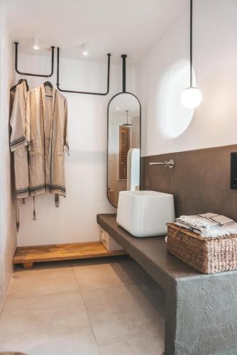a bathroom with a sink and a mirror at Kalkan Han Hotel in Kalkan
