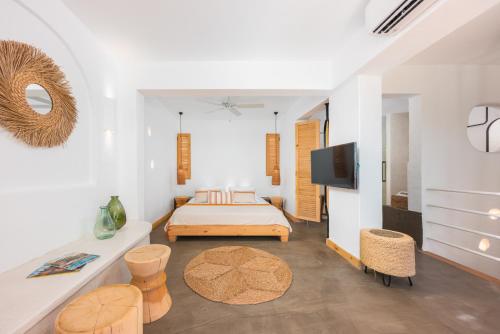 a bedroom with a bed and a tv in a room at Kalkan Han Hotel in Kalkan