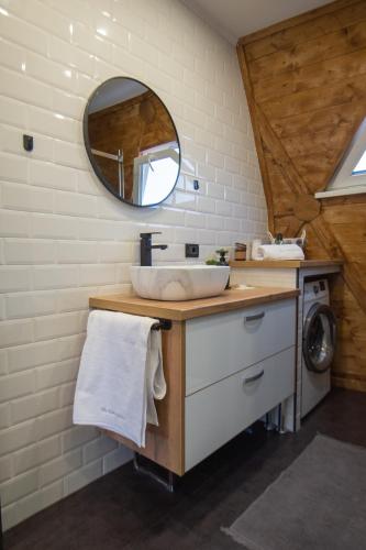 a bathroom with a sink and a mirror at The Dome Breaza (BV) in Breaza