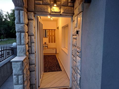 a hallway with a door leading to a porch at Kuća za odmor "Arija" in Zlobin