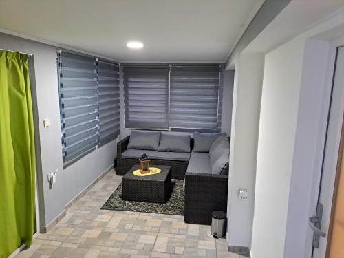 a small living room with a couch and a table at Kuća za odmor "Arija" in Zlobin