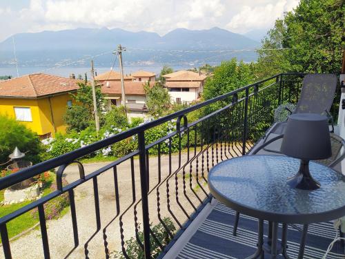 a balcony with a table and a view of the mountains at Villa dei Fiori in Luino