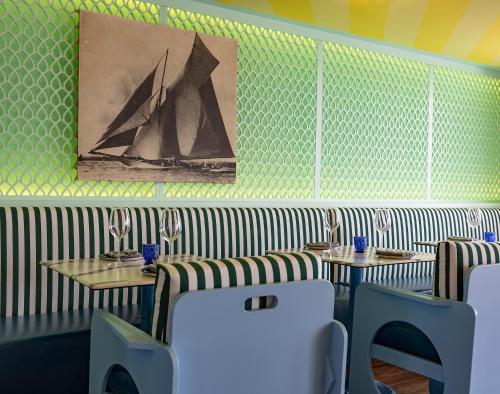a restaurant with two tables and chairs and a painting at Marina del Rey Hotel in Los Angeles