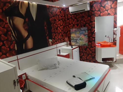 a room with a table with a phone on it at Motel Fest (Adults Only) in Santo André