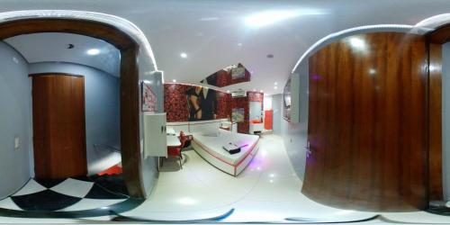 a bathroom with a sink and a large mirror at Motel Fest (Adults Only) in Santo André