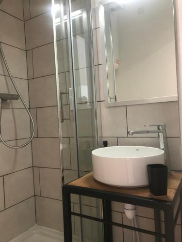 a bathroom with a white sink and a mirror at Studio 2 adultes 2 enfants Sanary sur Mer à 800m de la mer in Sanary-sur-Mer