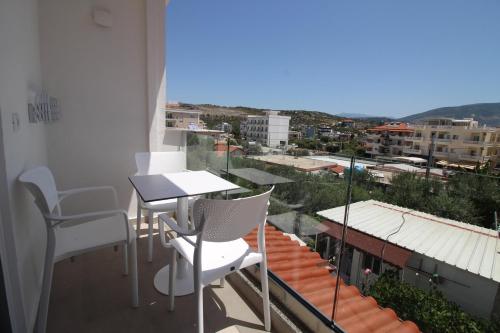 a balcony with a table and chairs and a view at Vila Ori in Ksamil