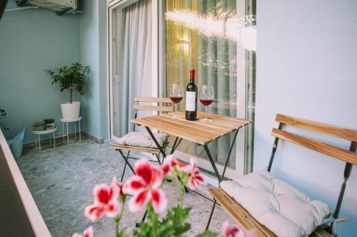 a table with a bottle of wine and two glasses at Apartments Toni in Split
