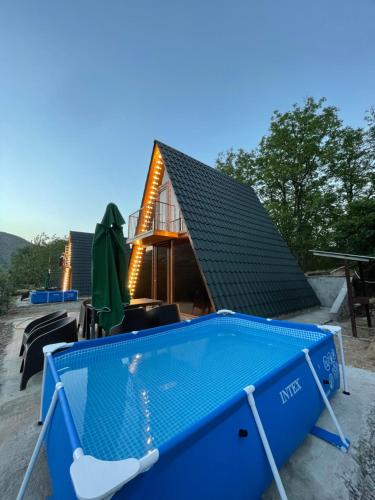 a house with a blue swimming pool with a roof at Navasard Resort in Kapan