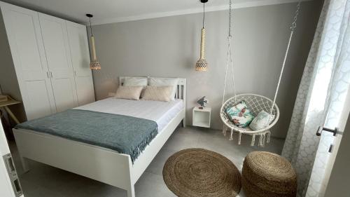 a bedroom with a swing bed and a chair at ViSun Apartment 3 in Vis