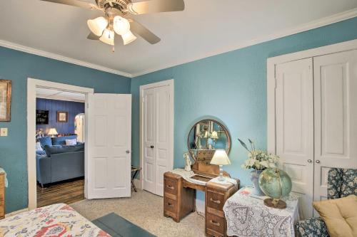 a living room with blue walls and a mirror at Eclectic Manitowoc Vacation Rental Near Marina! in Manitowoc