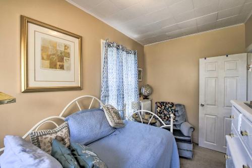 a living room with a blue couch and a window at Eclectic Manitowoc Vacation Rental Near Marina! in Manitowoc