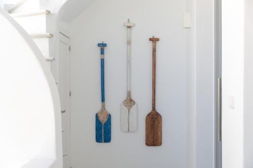 a row of wooden bats hanging on a wall at Kamvas Deluxe Apartments in Naxos Chora