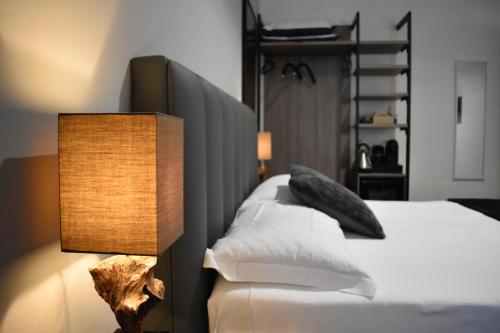 a bedroom with a bed with a lamp next to it at Marmore Charming House in Terni