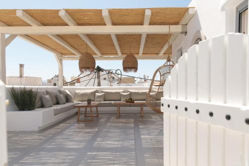 a patio with a couch and a table at Kamvas Deluxe Apartments in Naxos Chora
